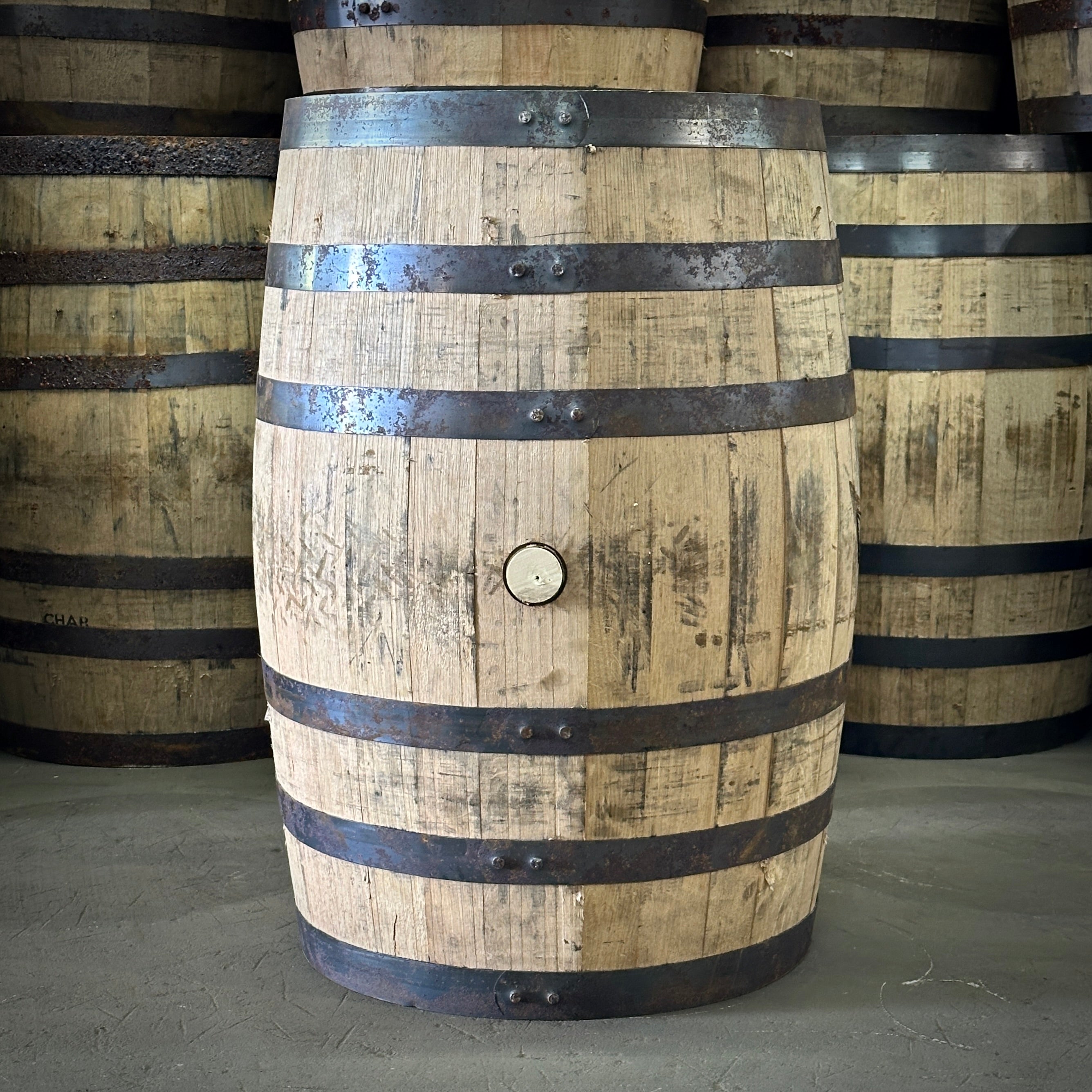 Wooden barrel with metal bands in a warehouse setting