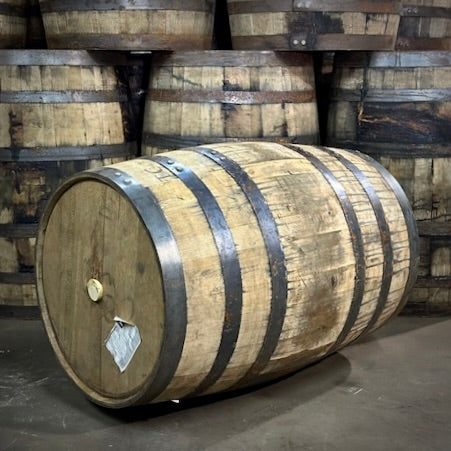 Wooden barrels stacked in a warehouse setting