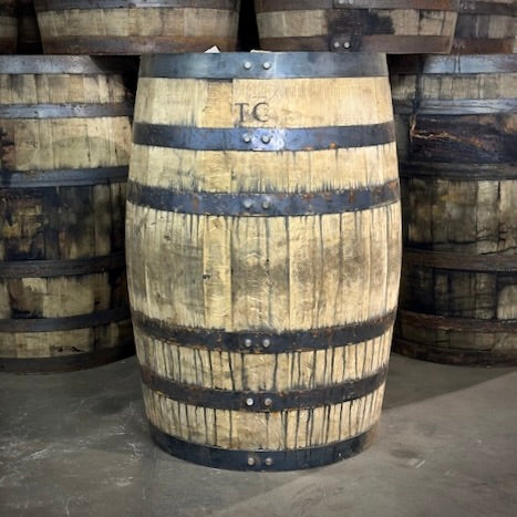 Wooden barrel with metal bands in a warehouse setting