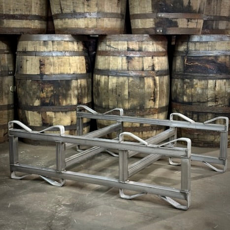 Metal pallet rack in front of stacked wooden barrels