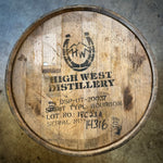 Wooden barrel with High West Distillery branding on a concrete surface