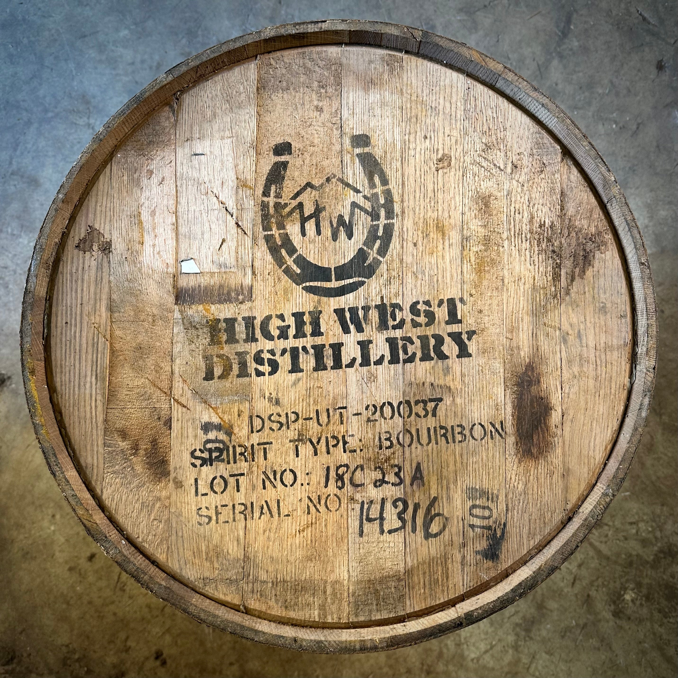 Wooden barrel with High West Distillery branding on a concrete surface