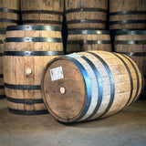 Wooden barrels with black bands on a concrete floor