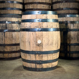 Wooden barrels with metal bands in a storage area