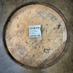 Wooden  rye bourbon barrel with a label on a concrete floor