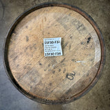 Wooden  rye bourbon barrel with a label on a concrete floor
