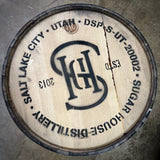 Wooden barrel head with Salt Lake City Utah Sugar House Distillery branding on a concrete surface