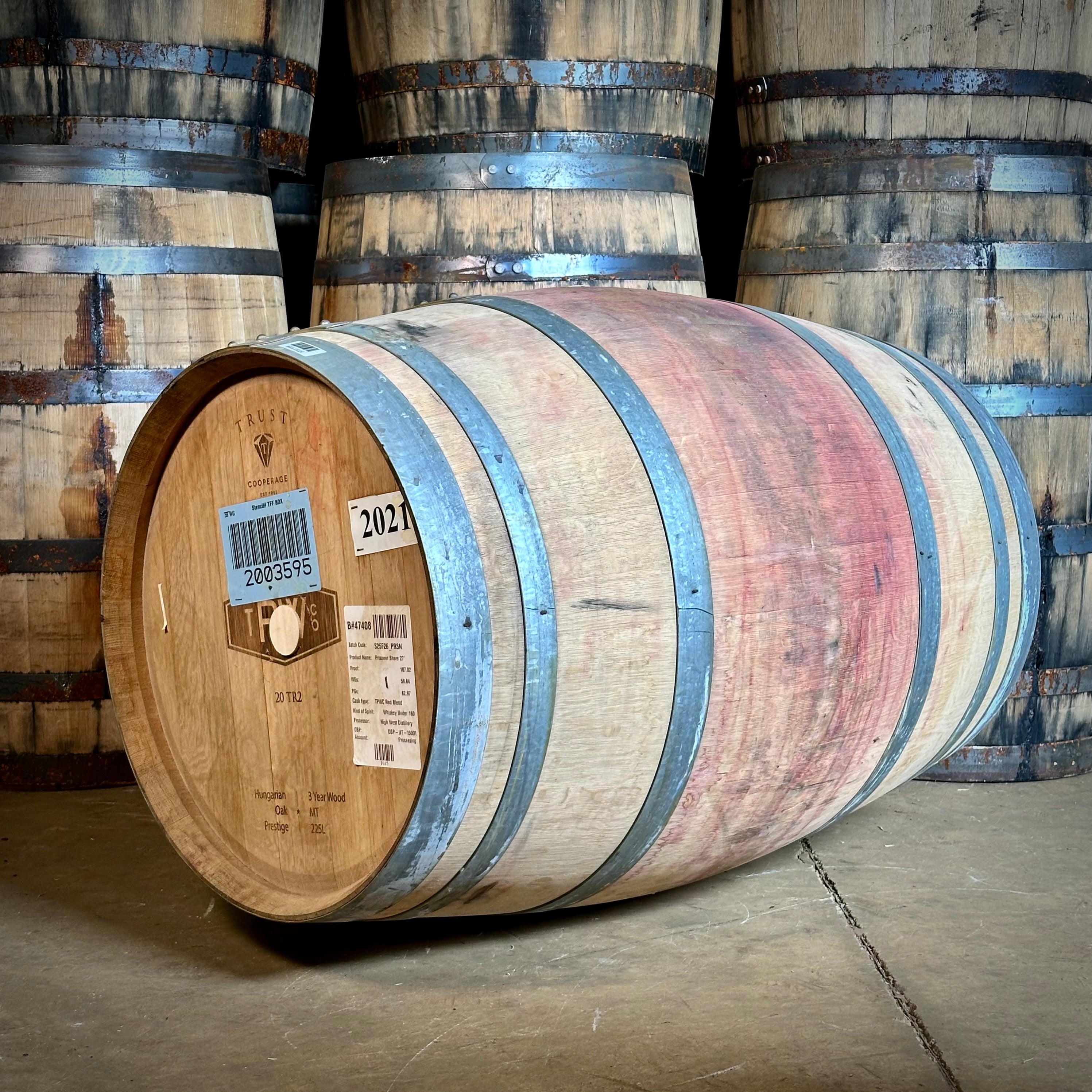 Wooden barrels with visible labels in the warehouse at Northeast Barrel Company